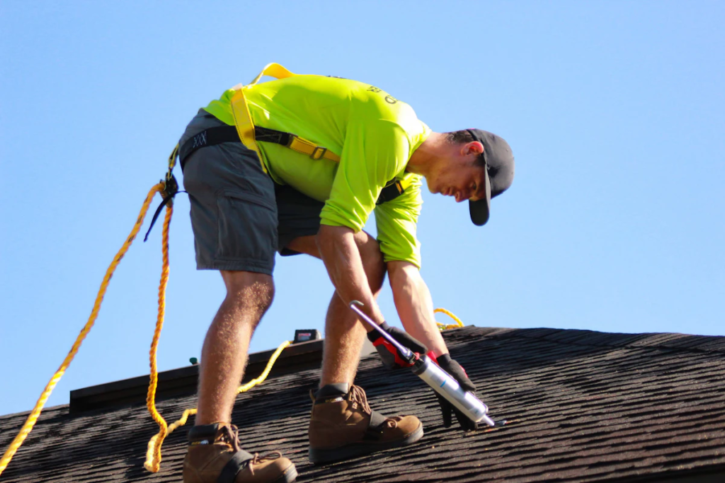 Roofer inspecting a residential shingle roof